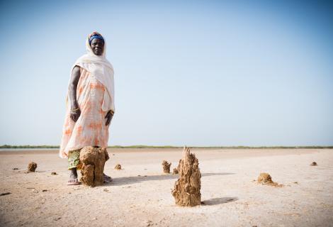 A photo of a woman in a drought area